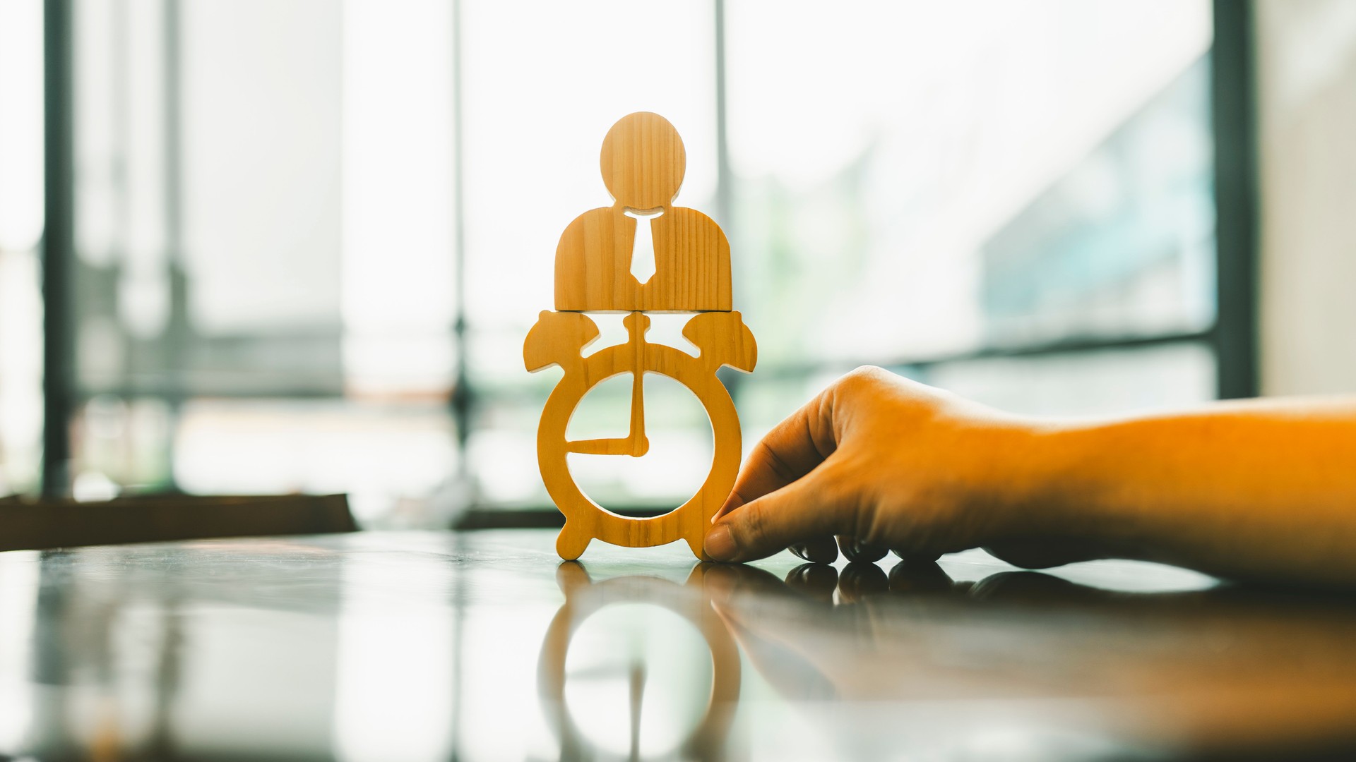 Hand holding icon of time model with a businessman on top, concept of time and vision, attitude about success, ,opportunities, future business trends and work life balance.